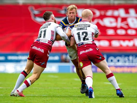 Jackson Hastings and Liam Farrell team up to halt Rhinos' Matt Prior in the game on August 16.