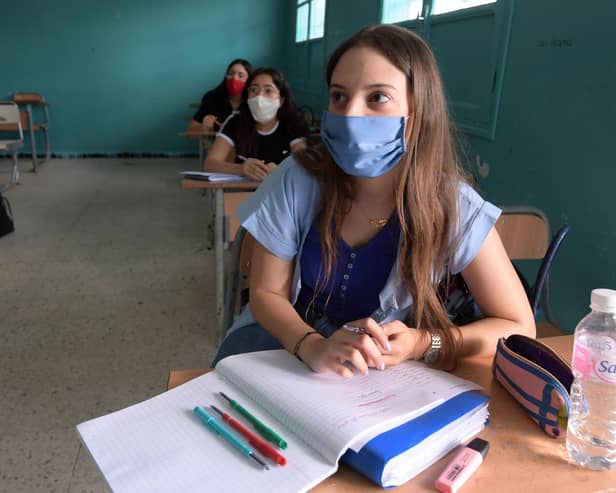 Pupils in a Tunisian high school students wearing face masks. But Yorkshire health and education chiefs want clarification on wearing them in schools in England. Photo credit: FETHI BELAID/Getty Images.