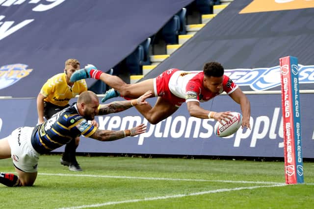 St Helens' Regan Grace (right) evades a tackle from Leeds Rhinos' Luke Briscoe at Emerald Headingley earlier this month. Picture: Martin Rickett/PA Wire.