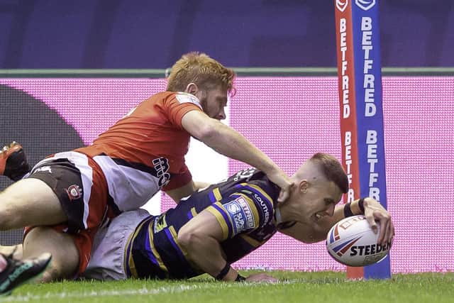 Salford's Kris Welham can't prevent Leeds Rhinos' Ash Handley scoring a try. Picture: Allan McKenzie/SWpix.com.