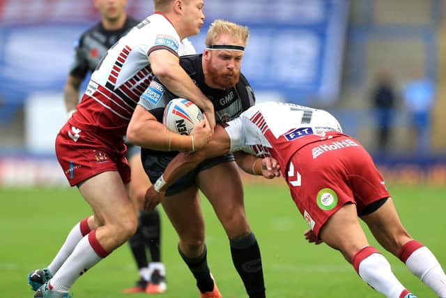 Tigers' Oliver Holmes is tackled by Wigan duo Morgan Smithies and Thomas Leuluai. Picture by Mike Egerton/PA Wire