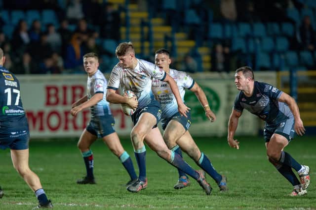 Brett Ferres, far right, closes in as Sam Walters makes a break for Leeds in a pre-season game at Featherstone. Picture by Bruce Rollinson.