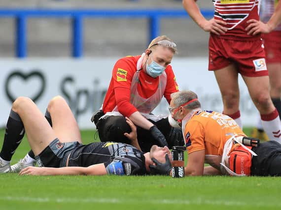 Medical staff attend to James Clare during Tigers' loss to Wigan. Picture by Mike Egerton/PA Wire.