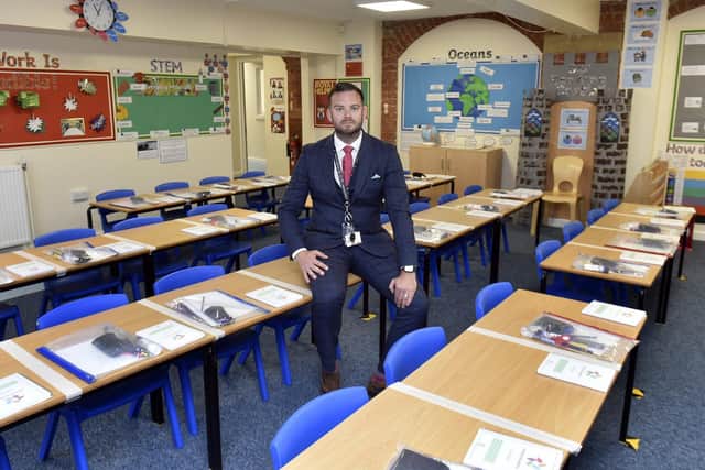 Sam Done shows how the classroom layouts have been changed to meet government instructions while keeping the colour and vibrancy of pupils' work.