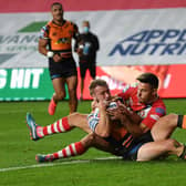 Danny Richardson scores Tigers' opening try, despite future teammate Niall Evalds' attempted tackle. Picture by Jonathan Gawthorpe.