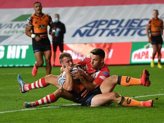 Danny Richardson scores Tigers' opening try, despite future teammate Niall Evalds' attempted tackle. Picture by Jonathan Gawthorpe.