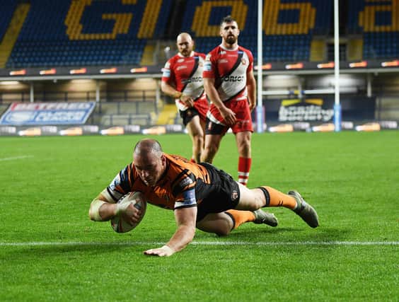 He's done it: Castleford Tigers' Grant Millington scores the winning try in their thrilling win over Salford Red Devils on Thursday night.

Picture: Jonathan Gawthorpe