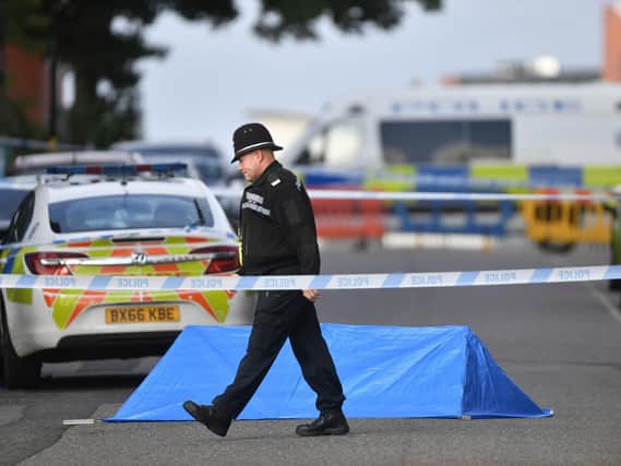 A police officer at a cordon in Irving Street in Birmingham after a number of people were stabbed in the city centre. PIC: PA