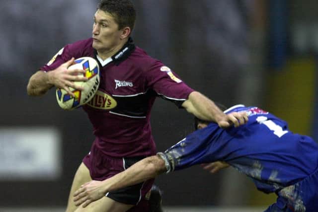 Leeds Rhinos' Brett Mullins hands off Wayne English in 2001. Picture: Mark Bickerdike.