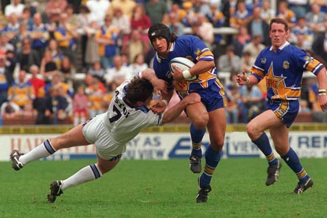 Nathan Picchi goes past Mark Aston on his debut for Leeds against Sheffield Eagles at Headingley. Picture: Steve Riding.