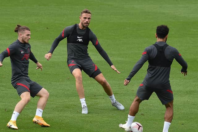BACK IN BUSINESS: Liverpool captain Jordan Henderson, centre. Photo by John Powell/Liverpool FC via Getty Images.