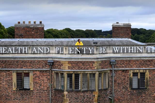 Head of housekeeping Maya Harrison pictured on top of Temple Newsam House where all the lettering has been painted. PIC: Simon Hulme