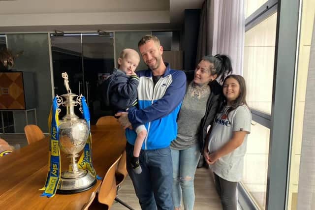 Ellis Price pictured on his Christmas Eve on Monday September 7 in a family photo with the Championshiop trophy at Elland Road