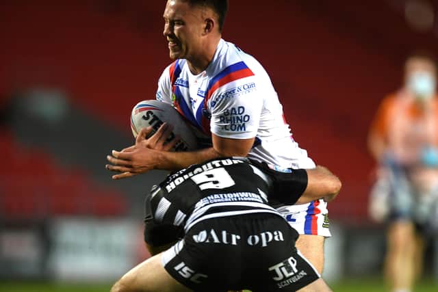 New face: Wakefield's Yusuf Aydin is tackled on his debut by Hull's Danny Houghton.Picture: Jonathan Gawthorpe