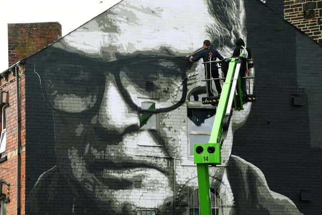 Artist Irek Jasutowicz puts the finishing touches to a new mural of Leeds United's Marcelo Bielsa on Hyde Park corner in Leeds. Picture : Jonathan Gawthorpe