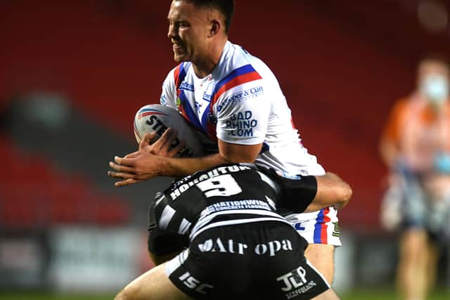 Wakefield's Yusuf Aydin is tackled by Hull's Danny Houghton.
 Picture: Jonathan Gawthorpe.