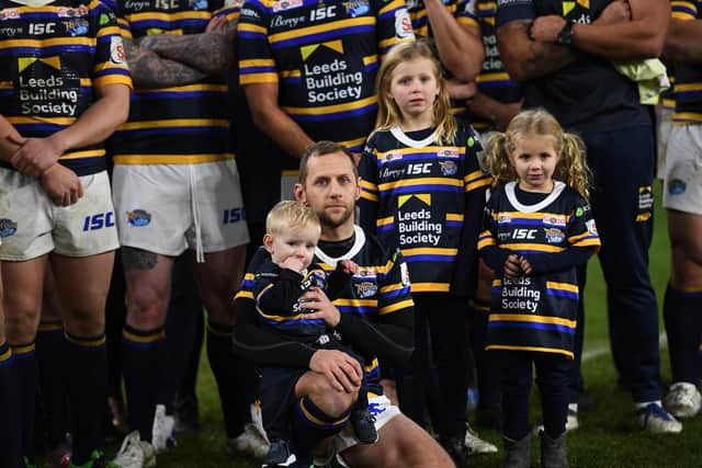 Rob Burrow on the pitch with his wife Lindsey and children Macy, Maya and Jackson.