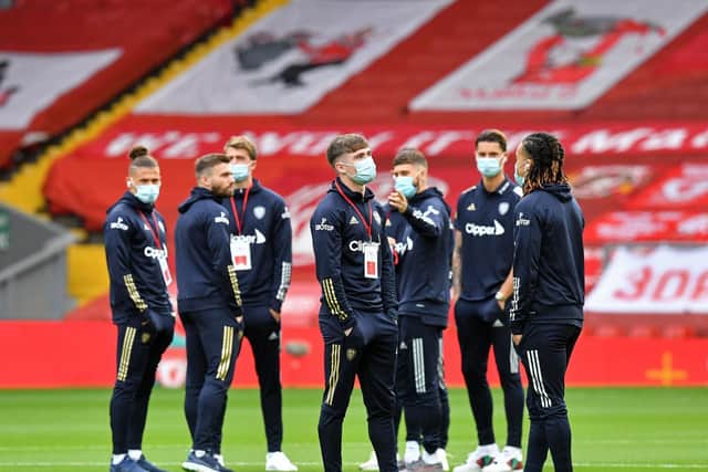 OPENER: Leeds United's players take to the pitch at Anfield. Photo by PAUL ELLIS/POOL/AFP via Getty Images.