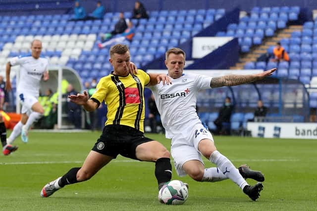 MOVING ON UP: Harrogate Town's Jack Muldoon (left) battles with Tranmere Rovers' Peter Clarke in last week's Carabao Cup clash at Prenton Park. Picture: Martin Rickett/PA
