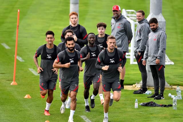 'PROMISING': Liverpool boss Jurgen Klopp, top, looks on as his Reds are put through their paces at Melwood this week with captain Jordan Henderson, right, back in full training. Photo by Andrew Powell/Liverpool FC via Getty Images.