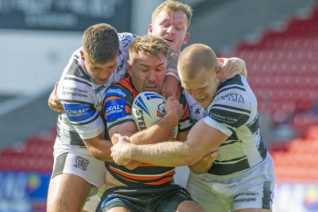 Castleford Tigers captain  Michael Shenton is wrapped up by the Hull defence. Picture: Tony Johnson/JPImedia.