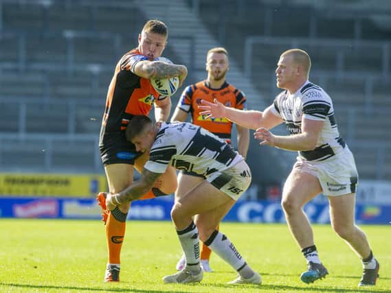 Tigers' Tyla Hepi is tackled by Joe Cator, of Hull. Picture by Tony Johnson.