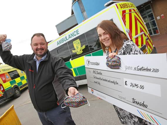 Transdev chief executive officerAlex Hornby hands over a cheque for 2,475 to Harrogate District Hospitals community and events fundraiser Georgia Hudson, representing NHS Charities Together,