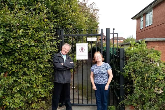 George Todd at the closed off ginnel at Murton Close, Seacroft along with fellow resident Heather.