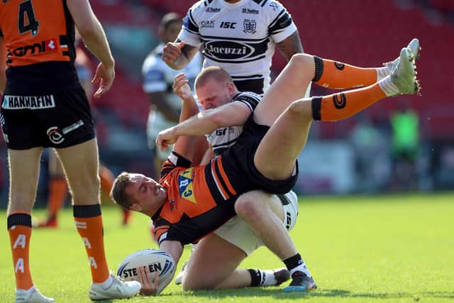 Castleford Tigers' James Clare is tackled by Brad Fash of Hull FC. Picture: Mike Egerton/PA Wire.