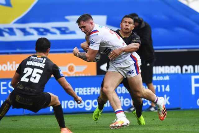 Wakefield's Jack Croft is tackled. (Picture: Jonathan Gawthorpe)