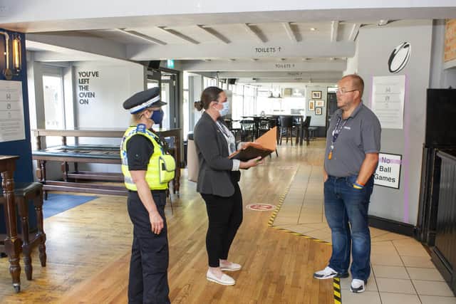 Ian Emms, team leader at the Original Oak in Headingley chats to Sophie Hardisty from Leeds City Council Enviromental Health team and PCSO 
Sam Pemberton.
