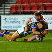 Over and out: 
Rhinos' Ash Handley scores the second try of eight tries int he Challenge Cup win over Hull KR. Picture: Jonathan Gawthorpe