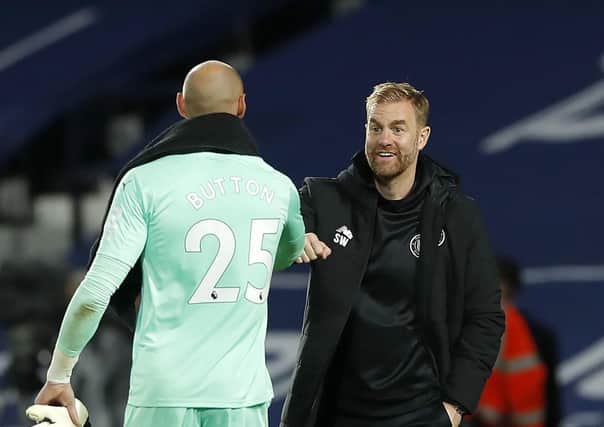 Harrogate Town manager Simon Weaver, right, bumps fists with West Bromwich Albion goalkeeper David Button after the Carabao Cup second round clash last week. Picture: Andrew Couldridge/NMC Pool/PA