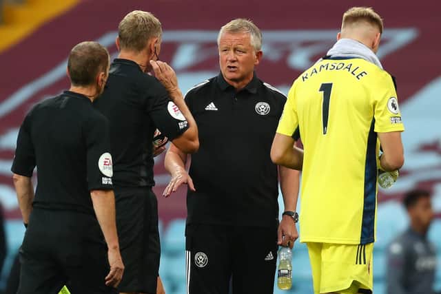 CONFUSED: Sheffield United boss Chris Wilder talks to referee Graham Scott after Blades captain John Egan is sent off. Photo by Clive Rose/Getty Images.