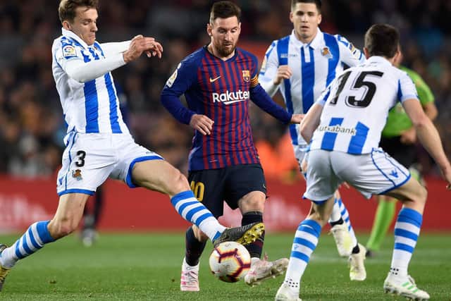 FACING THE BEST: Real Sociedad's Diego Llorente tackles Barcelona's Argentinian forward Lionel Messi at the Camp Nou stadium in the La Liga clash of April 2019. Photo by PAU BARRENA/AFP via Getty Images.