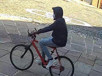 The 17-year-old girl was walking to work when the man cycled up behind her, grabbed her phone and drove off with it. CCTV image provided by West Yorkshire Police.