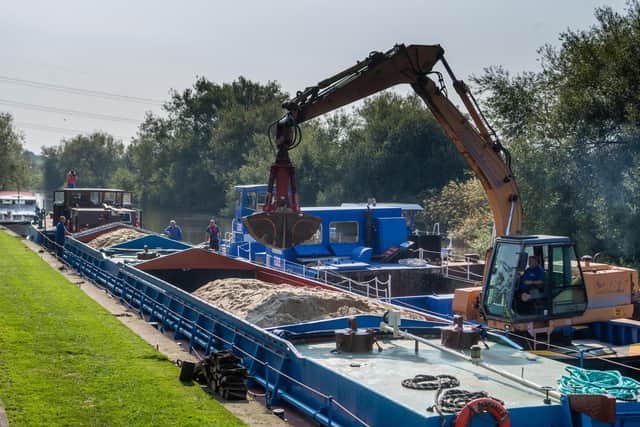 A vessel from the Canal and River Trust had to be brought in to off-load around 50 tons of sand before they would be able to carry on into Leeds. Picture: James Hardisty