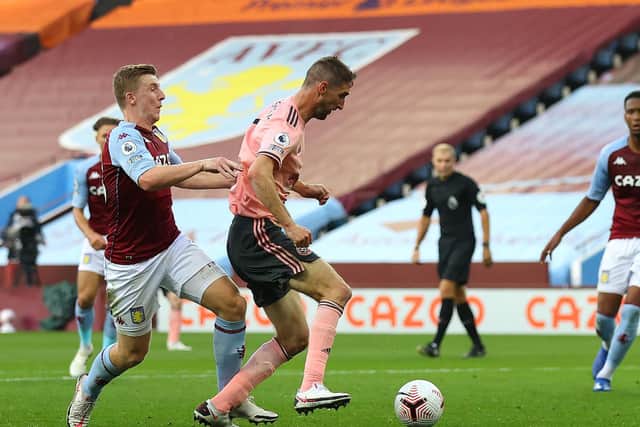 SPOT OF BOTHER: Sheffield United defender Chris Basham is caught by Aston Villa's Matt Targett for a penalty which the Blades then missed. Photo by Julian Finney/Getty Images.