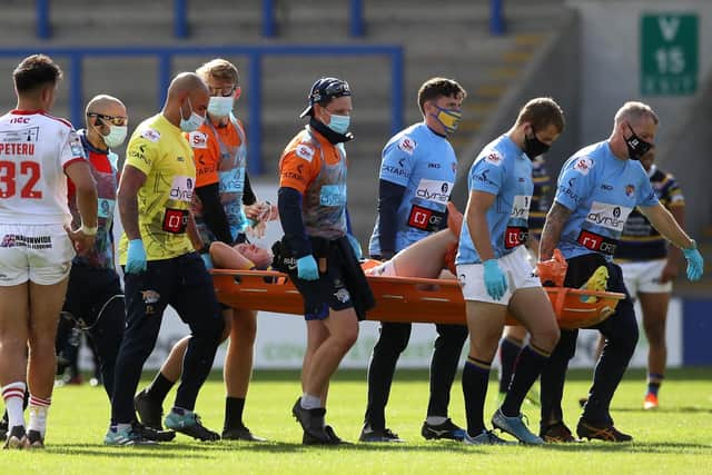 Leeds Rhinos' Harry Newman is stretchered off at the Halliwell Jones Stadium. Picture: Martin Rickett/PA Wire.