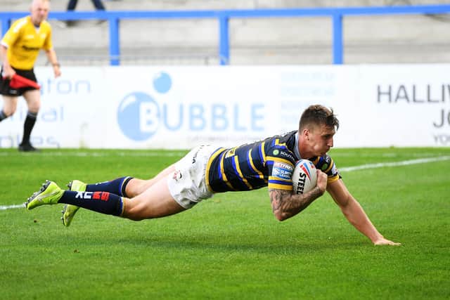 Smart Alex: Rhinos' Alex Mellor dives over to score his second-half try. Picture: Jonathan Gawthorpe