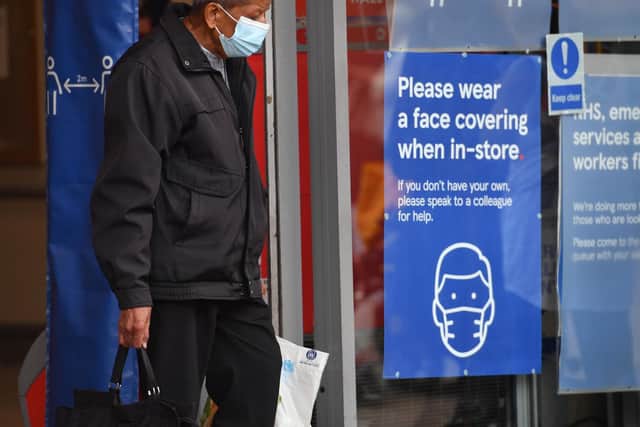 A shopper wearing a face mask leaves Tesco (Photo: Jacob King/PA Wire)