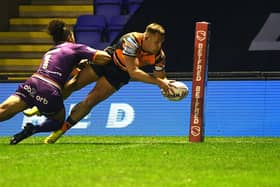 Greg Eden scores Tigers' opening try against Huddersfield. Picture by Jonathan Gawthorpe.