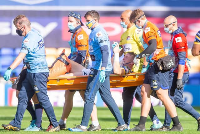 Leeds's Harry Newman is stretchered off after a leg injury against Hull KR. (Picture: SWpix.com)