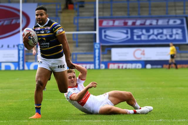 Rhinos' Kruise Leeming gets away from Rovers Jez Litten (Picture: Jonathan Gawthorpe)