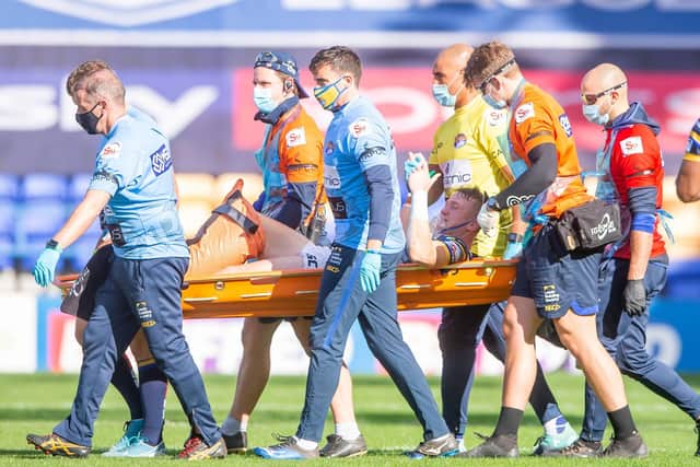 Leeds's Harry Newman is stretchered off after a leg injury against Hull KR. (Picture: SWPix.com)