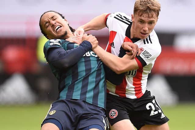 TIGHT TUSSLE: Leeds United's Helder Costa and Sheffield United's Ben Osborn battle for the ball. Picture: PA.