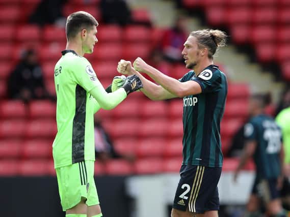 Illan Meslier celebrates with Luke Ayling at full-time against Sheffield United. (Getty)