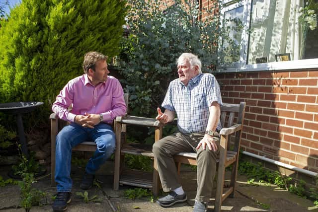 Roland Marchant speaks with his son Jason in the garden at his home in Leeds.