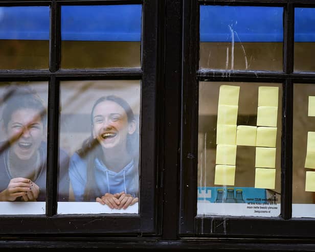 Pictured, students from Glasgow University look out of the windows of the student accommodation at Murano Street student village on September 28, 2020 in Glasgow, Scotland. Photo credit: Jeff J Mitchell/Getty Images
