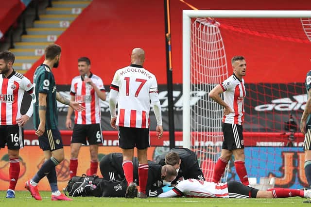 MAN DOWN: Sheffield United's Jack Robinson receives treatment after taking a Rodrigo thunderbolt in the face. Picture by Molly Darlington/PA Wire.